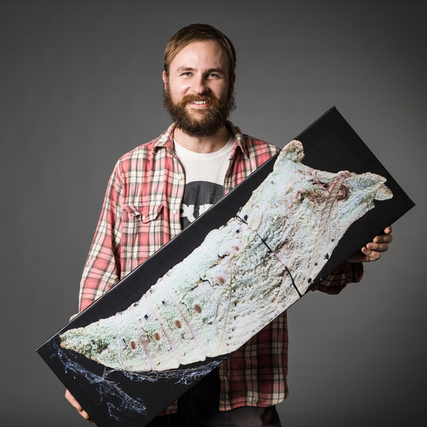 jonathan bremer with a photo of a butterfly pupa