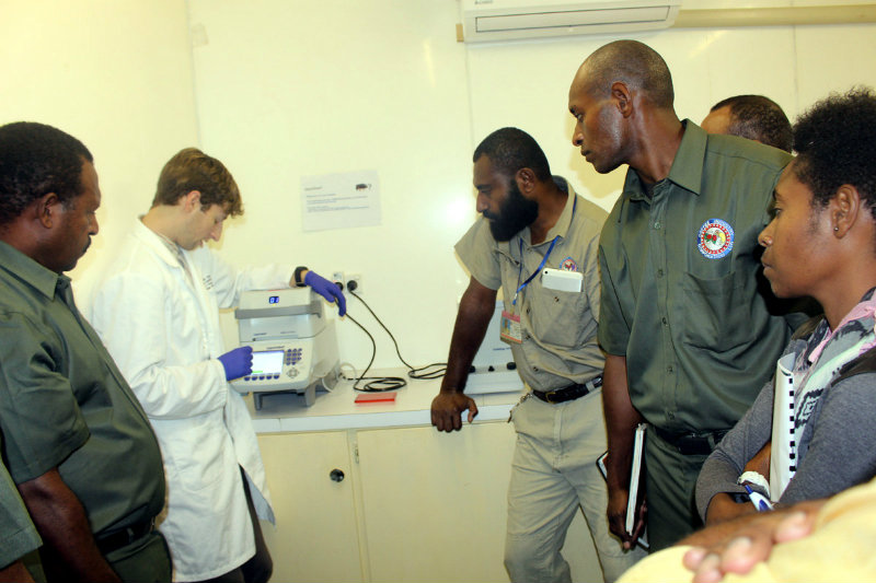 UF doctoral student Craig Bateman is shown here training New Guinean authorities to spot the coffee berry borer in Papua New Guinea’s coffee.