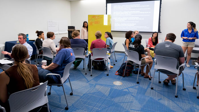 students, faculty and staff in small group discussions