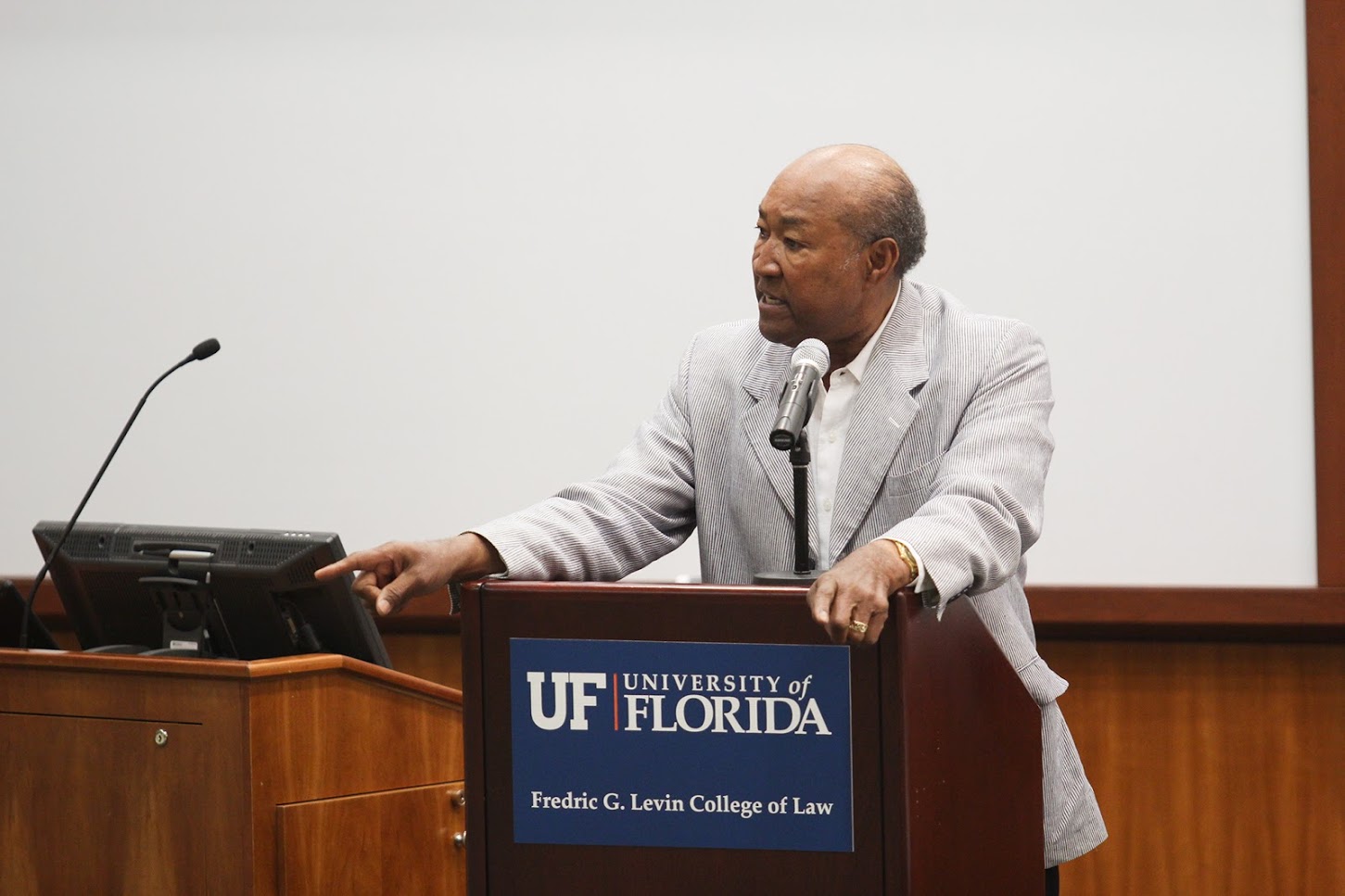 A man stands at a podium with a university of florida sign on it